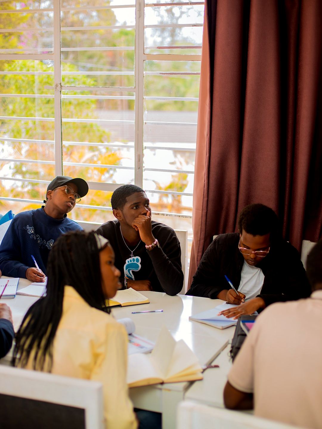 Students taking notes during a German class at Deutsch Sprache Rwanda