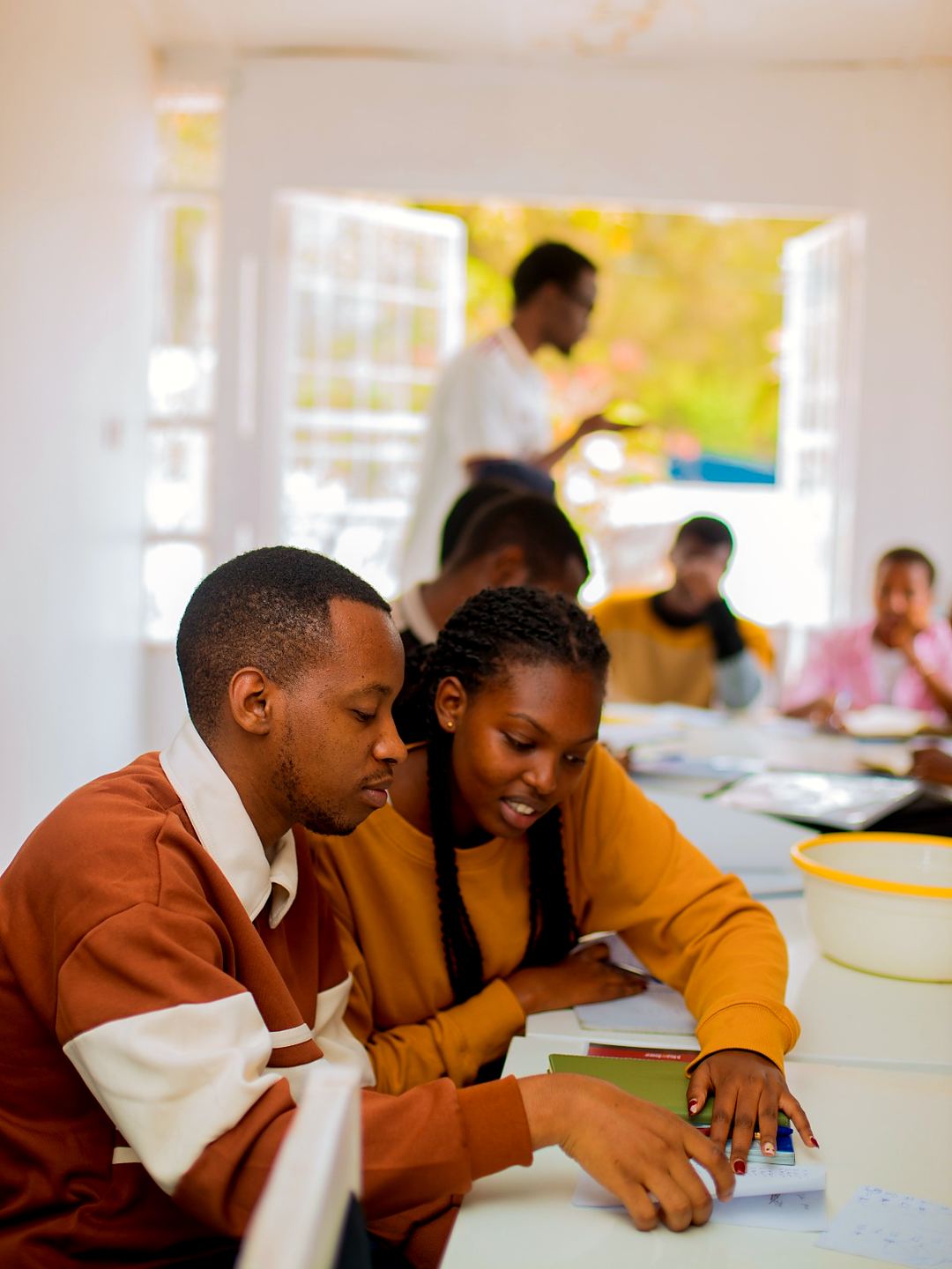 Two students working through a German exercise together in class