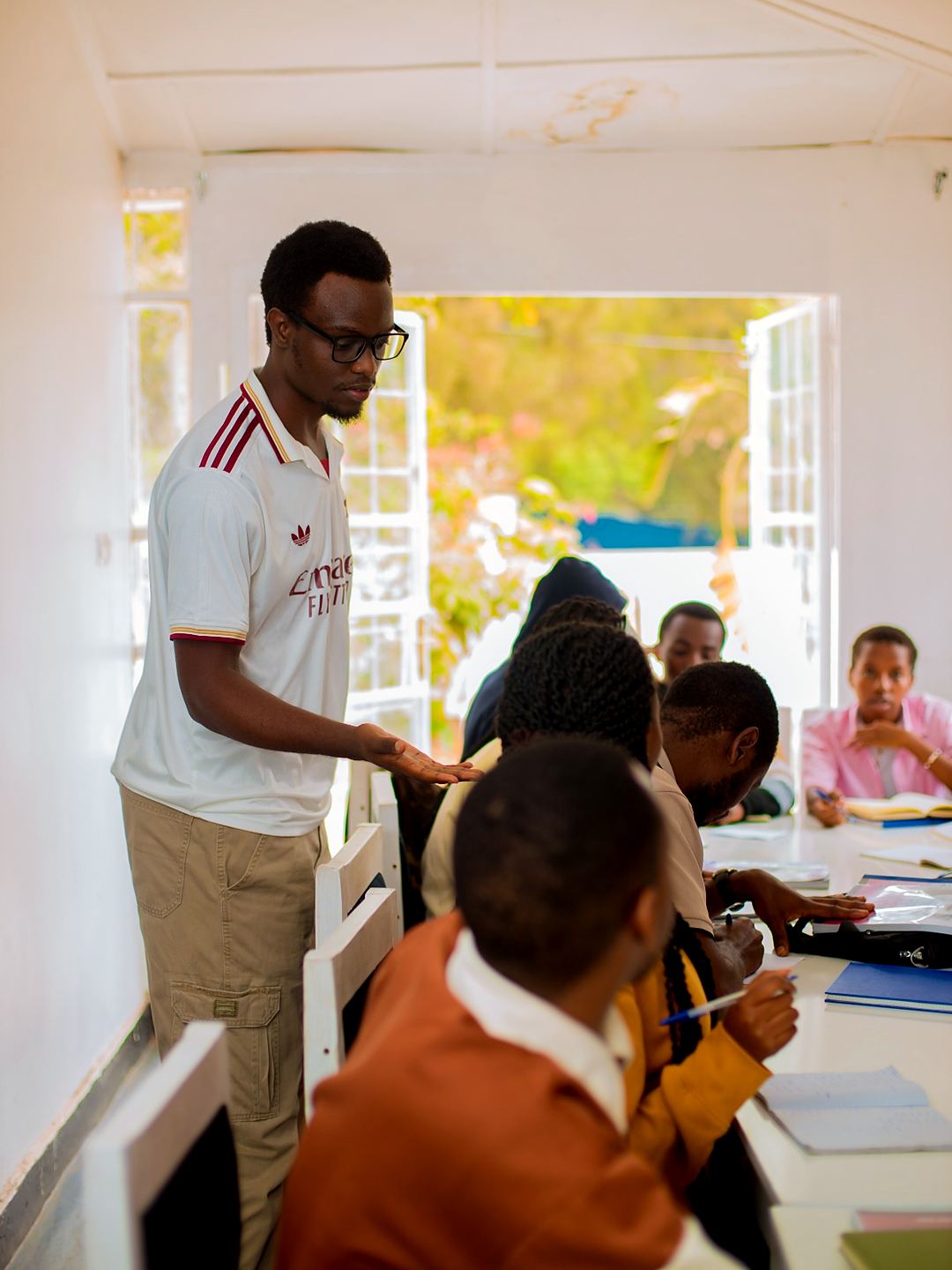 An instructor checking a student's work during a German lesson